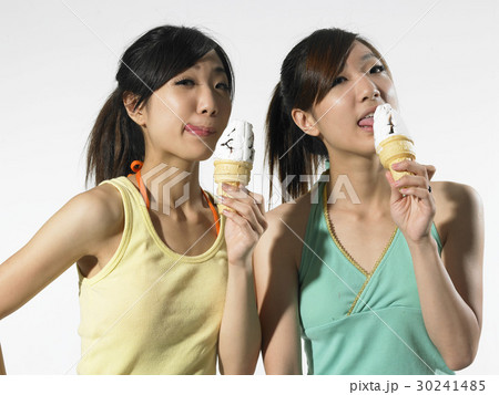 2人 若い女性 アイスクリームコーン なめることの写真素材