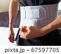 Old Man with Back Pain Wearing Back Support Belt or Medical Belt