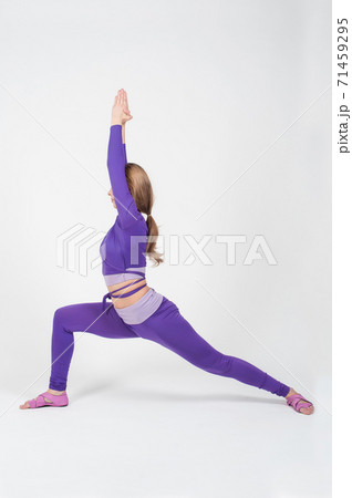 Beautiful Woman in Purple Leggings and Top Posing on a White