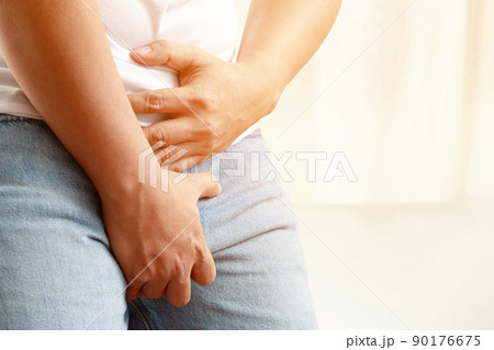 Hands Woman Holding Her Crotch And Lying On Bed,Female Need To Pee