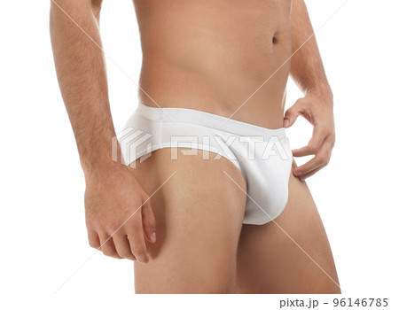 Man in underwear standing isolated on grey background covering his